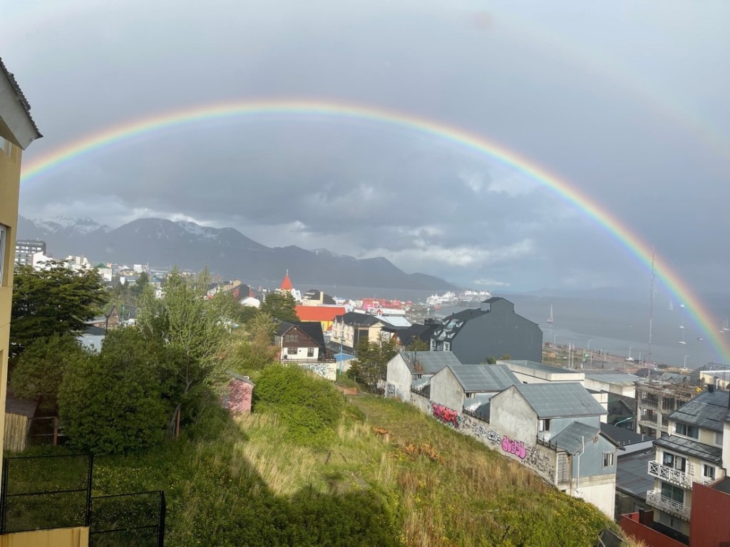 A rainbow over a small coastal town
